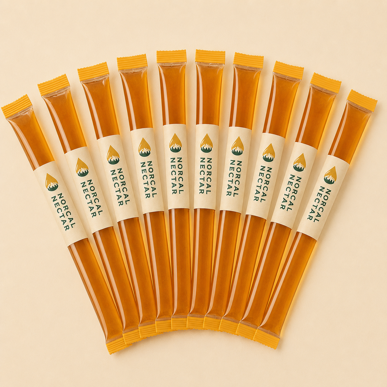 A fan of NorCal Nectar raw honey sticks, each wrapped in a cream label